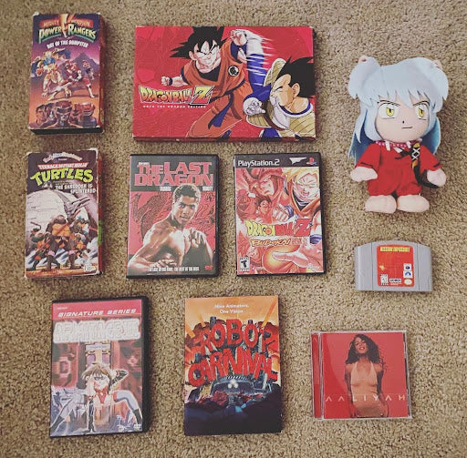 A selection of vivid red items from a collection of 80s, 90s, and 2000s anime, comic books, cartoons, video games, and collectibles.